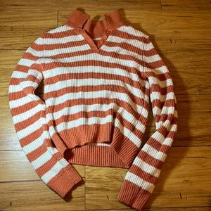 Orange and white striped sweater.
